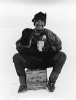 Steward Hooper eating baked beans on a wooden box advertising Heinz