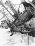 Ernest Shackleton leaning over the side of the Endurance