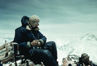 George Lowe changes a roll of film in his camera at 27,300 feet