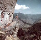 George Lowe standing in front of the Mani Wall before Jumbesi