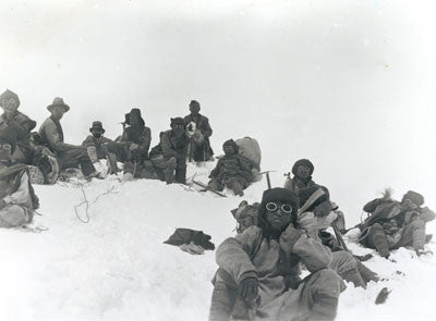 Team members including Mallory and Sherpas at a rest stop on Everest