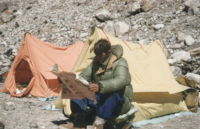 Edmund Hillary reading a newspaper (New Zealand Illustrated) at Camp I