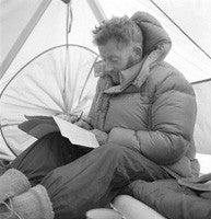 Charles Evans writing in his tent at Base Camp