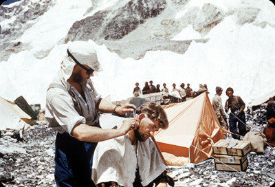 Charles Evans cutting George Lowe's hair at Base camp