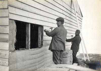 Robert Forde and George Abbott building a hut