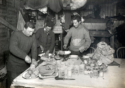 Dr. Atkinson, Henry Bowers and Apsley Cherry-Garrard cutting up pemmican