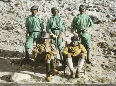 Norton (left) and a fellow climber with three porters