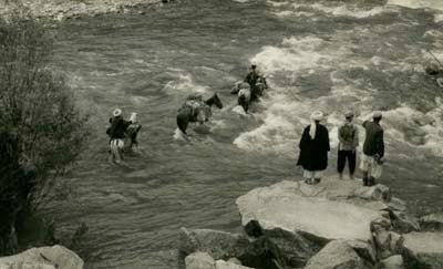 Fording a river in the Hindu Kush